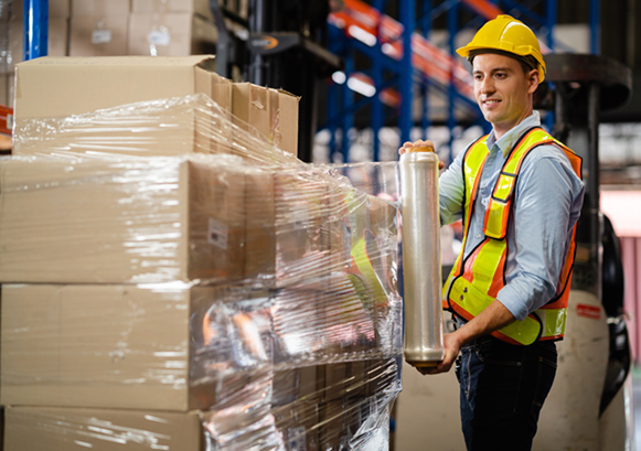 Warehouse packaging operation preparing cartons and palletized freight